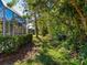 Lush backyard with mature trees and a natural pathway at 6642 Tailfeather Way, Bradenton, FL 34203