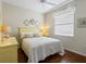 Cozy bedroom with a yellow headboard and neutral bedding at 6642 Tailfeather Way, Bradenton, FL 34203