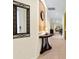 Bright entryway with a half-wall table and mirror at 6642 Tailfeather Way, Bradenton, FL 34203
