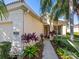 Exterior view of a single-story house with well-manicured landscaping and a walkway at 6642 Tailfeather Way, Bradenton, FL 34203