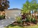House exterior showcasing a garage and lush landscaping at 6642 Tailfeather Way, Bradenton, FL 34203
