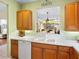 Kitchen features white countertops and wood cabinets at 6642 Tailfeather Way, Bradenton, FL 34203