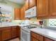 White appliances and light wood cabinets in this kitchen at 6642 Tailfeather Way, Bradenton, FL 34203