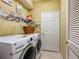 Laundry room with washer, dryer, and ample storage at 6642 Tailfeather Way, Bradenton, FL 34203