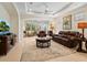 Spacious living room featuring leather furniture and a large TV at 6642 Tailfeather Way, Bradenton, FL 34203