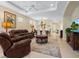 Open living room and dining area with leather furniture at 6642 Tailfeather Way, Bradenton, FL 34203