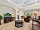 Living room with brown leather furniture and a large TV at 6642 Tailfeather Way, Bradenton, FL 34203