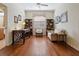 Home office with wood floors, built-in shelving, and a comfy couch at 6642 Tailfeather Way, Bradenton, FL 34203
