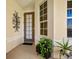 Small patio with potted plants and a door leading inside at 6642 Tailfeather Way, Bradenton, FL 34203