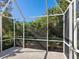 Spacious screened-in porch overlooking a lush backyard at 6642 Tailfeather Way, Bradenton, FL 34203