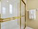 Clean bathroom with a gold-framed glass shower at 6642 Tailfeather Way, Bradenton, FL 34203