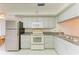 Galley kitchen with granite countertops and stainless steel appliances at 7135 27Th W Ave # 7135, Bradenton, FL 34209