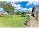 Landscaped lawn with walkway and trees at 7135 27Th W Ave # 7135, Bradenton, FL 34209