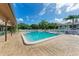 Community pool with lounge chairs and patio at 7135 27Th W Ave # 7135, Bradenton, FL 34209