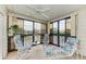 Bright sunroom with seating and ceiling fan at 7135 27Th W Ave # 7135, Bradenton, FL 34209