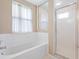 Bathroom with soaking tub, shower, and window for natural light at 7335 Fountain Palm Cir # 7335, Bradenton, FL 34203