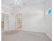 Bright bedroom with carpet flooring, an open doorway to the bathroom, and a ceiling fan at 7335 Fountain Palm Cir # 7335, Bradenton, FL 34203