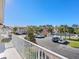 View of community pool, parking lot, and other houses from a balcony at 7335 Fountain Palm Cir # 7335, Bradenton, FL 34203