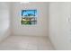 Simple dining room with tiled floors and a balcony view at 7335 Fountain Palm Cir # 7335, Bradenton, FL 34203