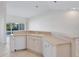 Kitchen with white cabinets, corner sink, and access to a patio at 7335 Fountain Palm Cir # 7335, Bradenton, FL 34203