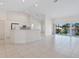 Open kitchen with island, white cabinets, and tile flooring at 7335 Fountain Palm Cir # 7335, Bradenton, FL 34203