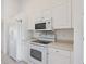 White kitchen with built-in microwave and oven at 7335 Fountain Palm Cir # 7335, Bradenton, FL 34203