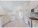 Clean kitchen with white cabinets, black appliances, and a breakfast bar at 7335 Fountain Palm Cir # 7335, Bradenton, FL 34203