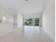 Bright and airy living room with tile floor and sliding glass doors at 7335 Fountain Palm Cir # 7335, Bradenton, FL 34203