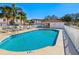 Community pool with surrounding lounge chairs and a fenced area at 7335 Fountain Palm Cir # 7335, Bradenton, FL 34203