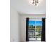Sliding glass doors open to a balcony overlooking a pool and lush landscaping at 7335 Fountain Palm Cir # 7335, Bradenton, FL 34203
