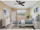 Spacious bedroom with a ceiling fan and a window with shutters at 8133 Miramar Way # 201, Lakewood Ranch, FL 34202