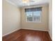 Well-lit bedroom featuring hardwood floors and a window with shutters at 8133 Miramar Way # 8133, Lakewood Ranch, FL 34202