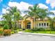 Community clubhouse with palm trees and landscaped grounds at 8133 Miramar Way # 201, Lakewood Ranch, FL 34202