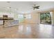Open living room and kitchen area with tile flooring and sliding glass doors at 8133 Miramar Way # 201, Lakewood Ranch, FL 34202