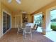 Covered outdoor kitchen and dining area with grill at 8133 Miramar Way # 201, Lakewood Ranch, FL 34202