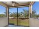 Screened porch overlooking a lush green backyard with palm trees at 8133 Miramar Way # 201, Lakewood Ranch, FL 34202
