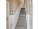 Interior view of a carpeted staircase with white railings at 8133 Miramar Way # 201, Lakewood Ranch, FL 34202