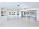 Open living room with tile floors and access to a sunroom at 104 Leland Se St, Port Charlotte, FL 33952