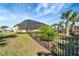 Landscaped backyard with a fenced area, offering privacy and tranquility at 118 Creek Se Dr, Port Charlotte, FL 33952