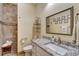 Bathroom with granite countertop, walk-in shower, and large mirror at 118 Creek Se Dr, Port Charlotte, FL 33952