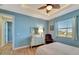 Bedroom with light blue walls, dresser and a queen-size bed at 118 Creek Se Dr, Port Charlotte, FL 33952