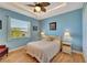 Bedroom with light blue walls and a queen-size bed at 118 Creek Se Dr, Port Charlotte, FL 33952