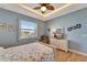 Guest bedroom with light blue walls, a queen-size bed, and hardwood floors at 118 Creek Se Dr, Port Charlotte, FL 33952