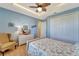Guest bedroom with light blue walls, a queen-size bed, and hardwood floors at 118 Creek Se Dr, Port Charlotte, FL 33952