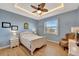 Guest bedroom with light blue walls, a queen-size bed, and hardwood floors at 118 Creek Se Dr, Port Charlotte, FL 33952