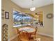 Breakfast nook with pool view, features a round wooden table and chairs at 118 Creek Se Dr, Port Charlotte, FL 33952
