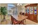 Elegant dining room featuring a wood table, chairs, and a china cabinet at 118 Creek Se Dr, Port Charlotte, FL 33952