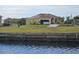 Single-Gathering home with attached garage, paved driveway and waterfront view at 118 Creek Se Dr, Port Charlotte, FL 33952