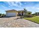 Beautiful waterfront home with paver driveway and landscaping at 118 Creek Se Dr, Port Charlotte, FL 33952