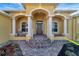 Inviting front porch with a rocking chair and decorative stonework at 118 Creek Se Dr, Port Charlotte, FL 33952